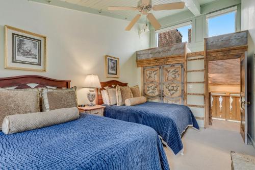 a bedroom with two beds and a ceiling fan at Interlude Condominiums 3-Bedroom Unit 302 in Snowmass Village