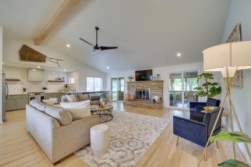 a living room with a couch and a fireplace at Well-Appointed Tulsa Home with Fire Pit and Patio! in Tulsa