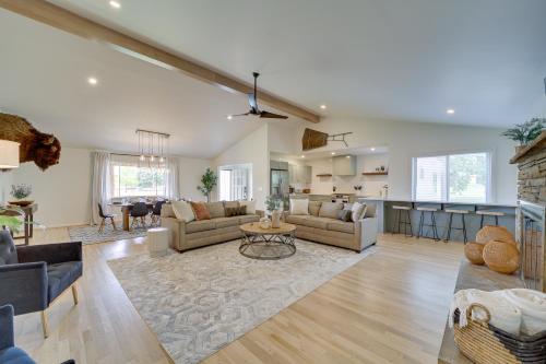a living room with a couch and a table at Well-Appointed Tulsa Home with Fire Pit and Patio! in Tulsa
