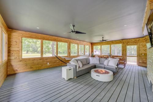 a living room with a couch and a fire pit at Well-Appointed Tulsa Home with Fire Pit and Patio! in Tulsa