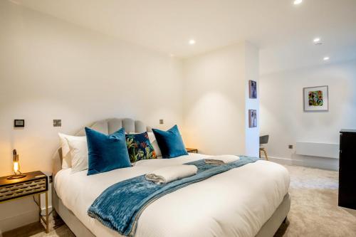 ein Schlafzimmer mit einem großen Bett mit blauen Kissen in der Unterkunft The Gallery at 403 in York