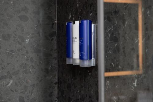a group of blue and white batteries on a wall at Hotel Keen in Palo Alto
