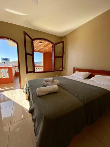 a bedroom with two beds with towels on them at Pousada Paraíso dos Corais in Arraial do Cabo