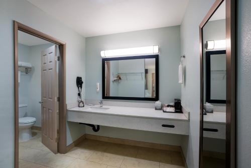 a bathroom with a sink and a mirror and a toilet at Quality Inn Fairfield Napa Valley Area in Fairfield