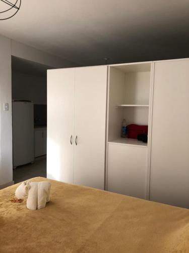 1 dormitorio con 1 cama con armarios blancos en Departamento céntrico a estrenar en San Juan