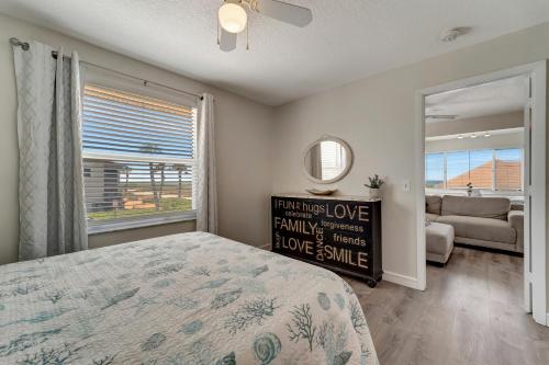 a bedroom with a bed and a window and a couch at Ocean View in Holmes Beach