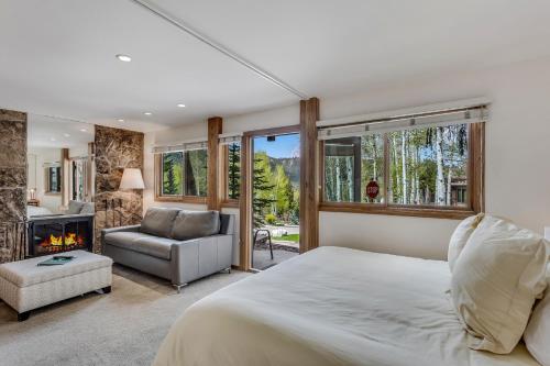 a bedroom with a bed and a fireplace at Laurelwood Condominiums 105 in Snowmass Village