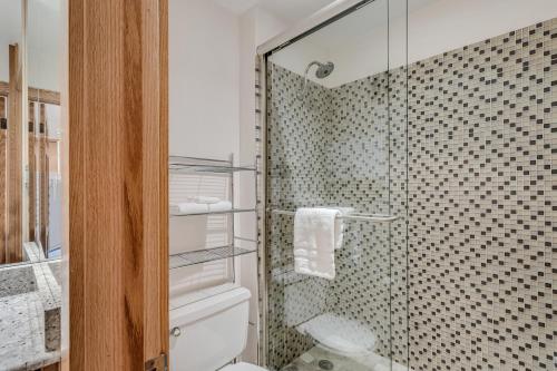 a bathroom with a toilet and a glass shower at Laurelwood Condominiums 105 in Snowmass Village