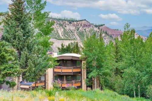 a building with trees in front of a mountain at Laurelwood Condominiums 105 in Snowmass Village