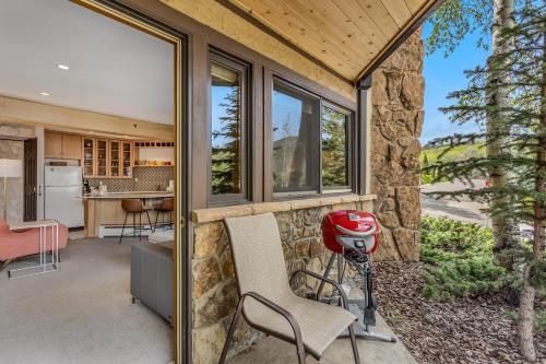 a home with a patio with a kitchen and a grill at Laurelwood Condominiums 105 in Snowmass Village