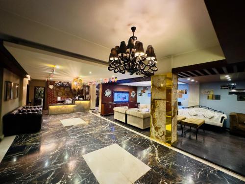 a large living room with a chandelier at The Elite Residence Dhaka in Dhaka