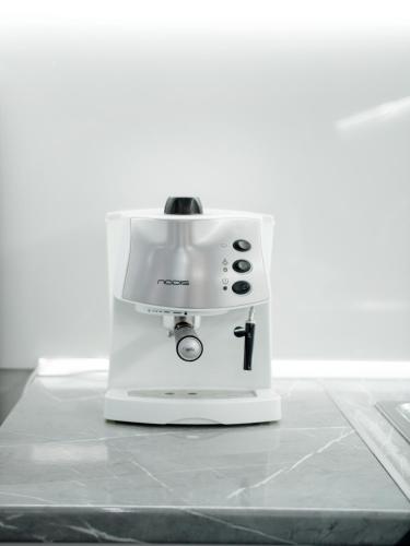 a white coffee maker sitting on a counter at Dionis House in Shkodër