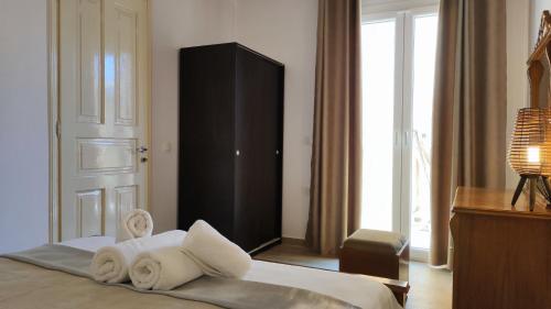 a bedroom with a bed with towels on it at Villa Amaryllis in Paleokastritsa