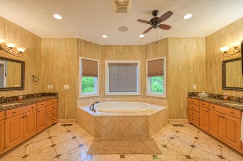 a large bathroom with a tub and a fan at Paradise at Sunset Cove in Moneta
