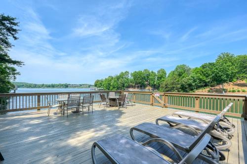 a deck with chairs and tables and a view of the water at Emerald Cove in Moneta