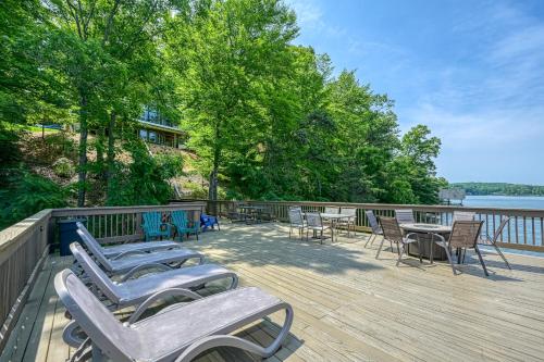 a deck with chairs and tables and a view of the water at Emerald Cove in Moneta