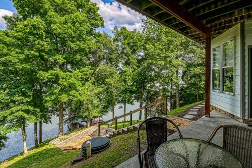 a porch with chairs and a view of the water at Still Waters in Moneta