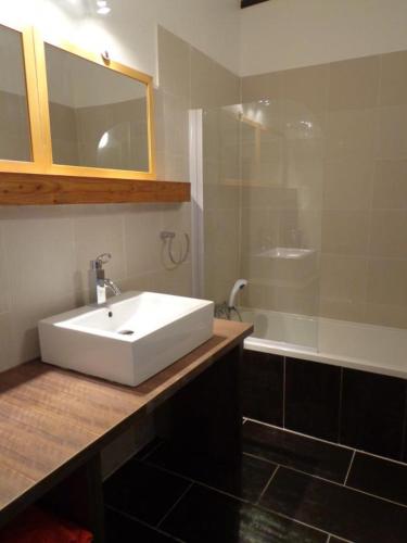 une salle de bain avec un lavabo blanc et une douche dans l'établissement Lo bonur es dens lo prat, à Soustons