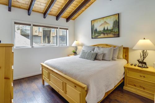 a bedroom with a large bed and two windows at Brian Head Condo Walk to Giant Steps Ski Lifts! in Brian Head