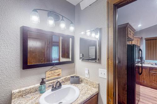 a bathroom with a sink and a mirror at Tumble Inn in Rapid City