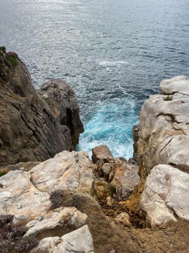 a view of the ocean from a rocky cliff at Pension Angelines, Sneuu Hostel Santander in Santander