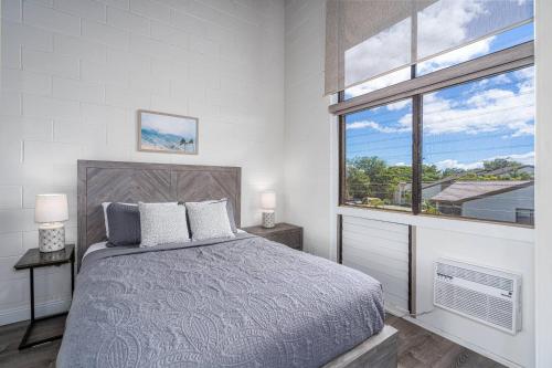 a bedroom with a large bed and a window at C7 Hono Kai in Wailuku