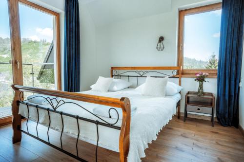 Posteľ alebo postele v izbe v ubytovaní Apartamenty Widok Tatr