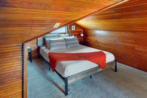 a bedroom with a bed in a room with wooden walls at Wallingford Heights in Seattle