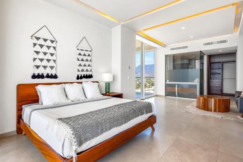 a bedroom with a large bed and a bathroom at Harbor 171 Oceanfront Residences #13011 in Puerto Vallarta