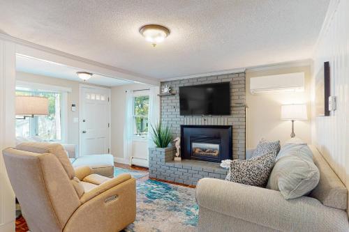 a living room with a couch and a fireplace at Sunset Cove Retreat in Wareham