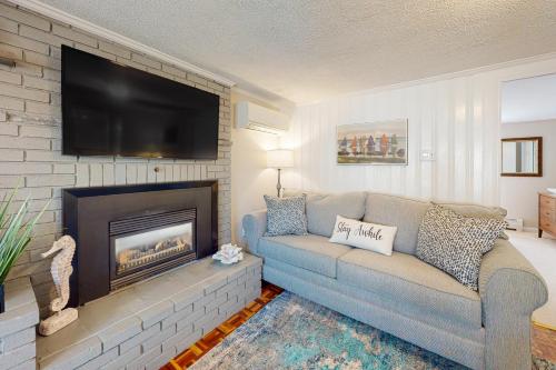 a living room with a couch and a fireplace at Sunset Cove Retreat in Wareham