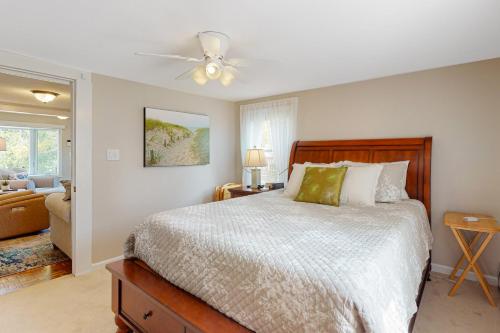 a bedroom with a bed and a ceiling fan at Sunset Cove Retreat in Wareham