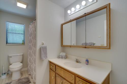 a bathroom with a sink and a toilet and a mirror at Peaceful Apt in Crossville about 8 Mi to Golf Courses! in Crossville