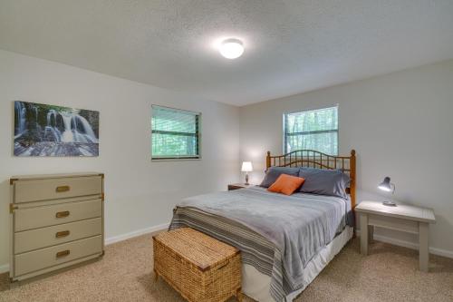 a bedroom with a bed and a dresser and windows at Peaceful Apt in Crossville about 8 Mi to Golf Courses! in Crossville