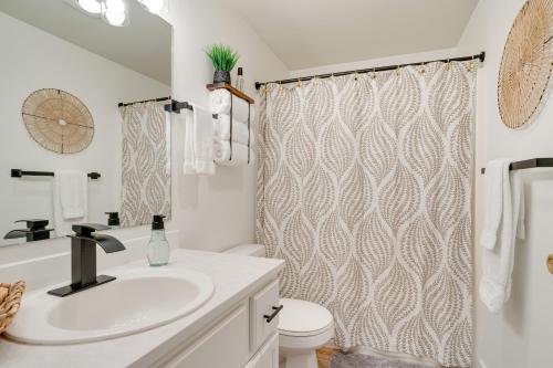 a bathroom with a sink and a shower curtain at Chelan Vacation Rental with Balcony and Views in Chelan