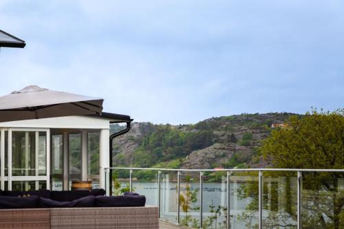 a house with a balcony with a view of the water at Exclusive house with private boathouse in Nösund