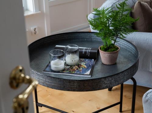 a black table with two glasses and a plant on it at Exclusive house with private boathouse in Nösund