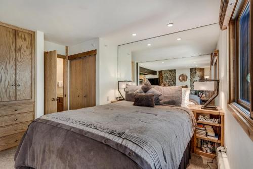 a bedroom with a large bed with a large mirror at Laurelwood Condominiums 109 in Snowmass Village