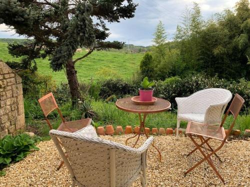 a table and two chairs and a table and a table and chairs at Studio indépendant /2 personnes in Le Bugue