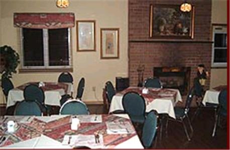 
a restaurant with tables and chairs in it at Clansman Motel in North Sydney
