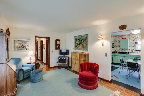a living room with a red chair and a table at Retro-Style Home in Ruston Walkable Location! 