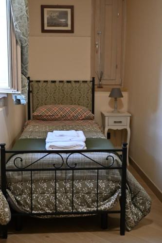 a bedroom with a bed with a black frame at Il poggio degli antichi sapori in Paternopoli