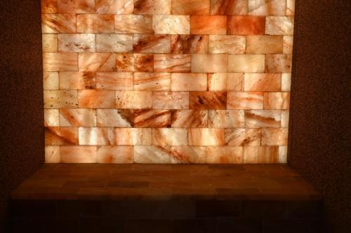 a brick wall with a wooden floor in a room at Il poggio degli antichi sapori in Paternopoli