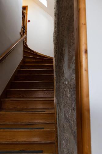 a staircase in a house with wooden floors at Schoolhouse in Ballater