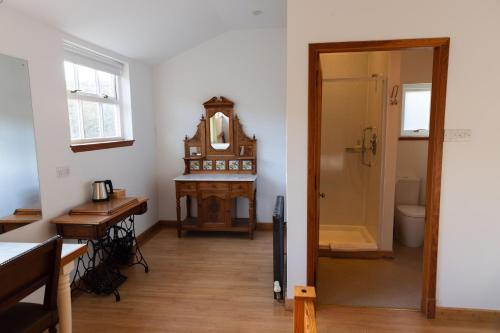 a room with a desk and a clock in a room at Schoolhouse Ballater B&B in Ballater