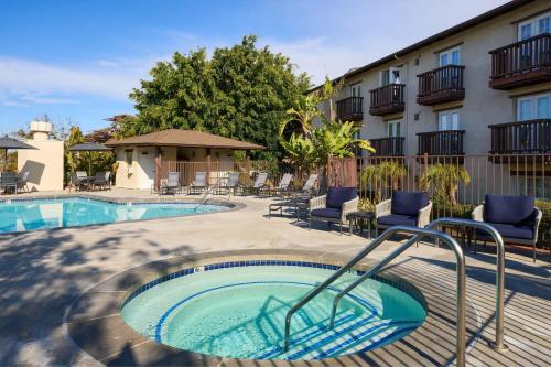 a swimming pool with chairs next to a building at Fairfield Inn & Suites San Diego Old Town in San Diego