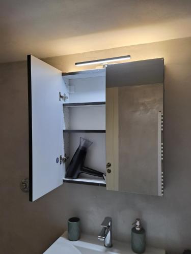 a mirror above a sink in a bathroom at Νέο στούντιο, Νέος Κόσμος in Athens