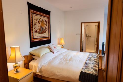 a bedroom with a bed and a picture on the wall at Schoolhouse in Ballater