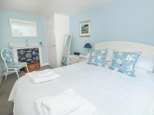 a bedroom with a large white bed with towels on it at Lake Victoria Cottage in Dartmouth