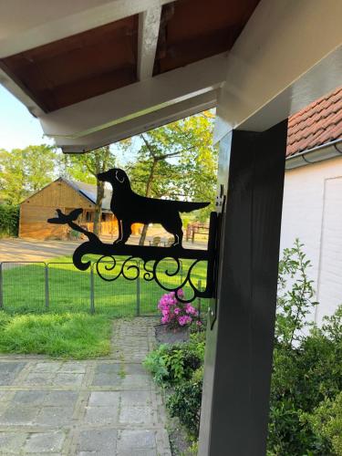 a statue of a dog on a fence at Horse and Hound in Riethoven